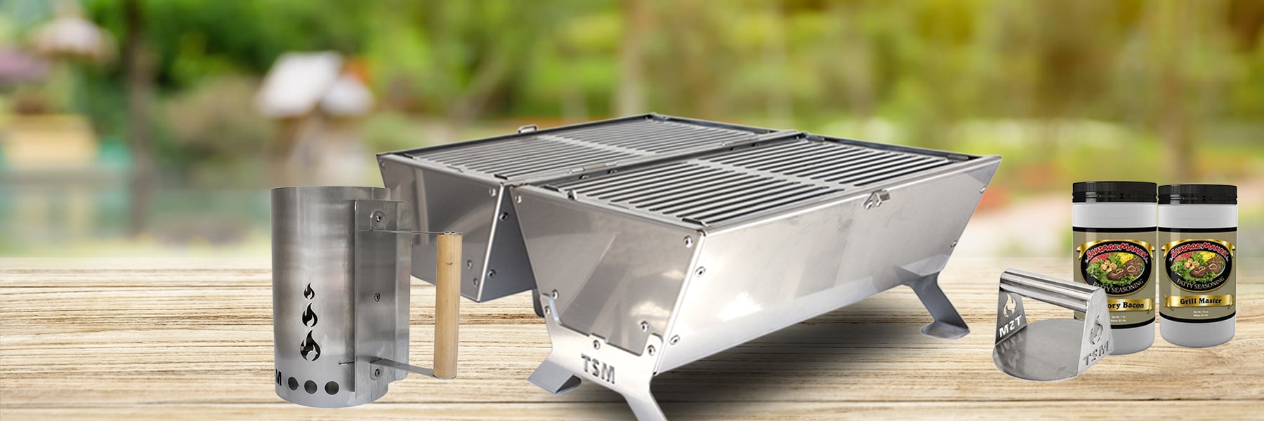 portable grill and charcoal starter chimney on a patio table