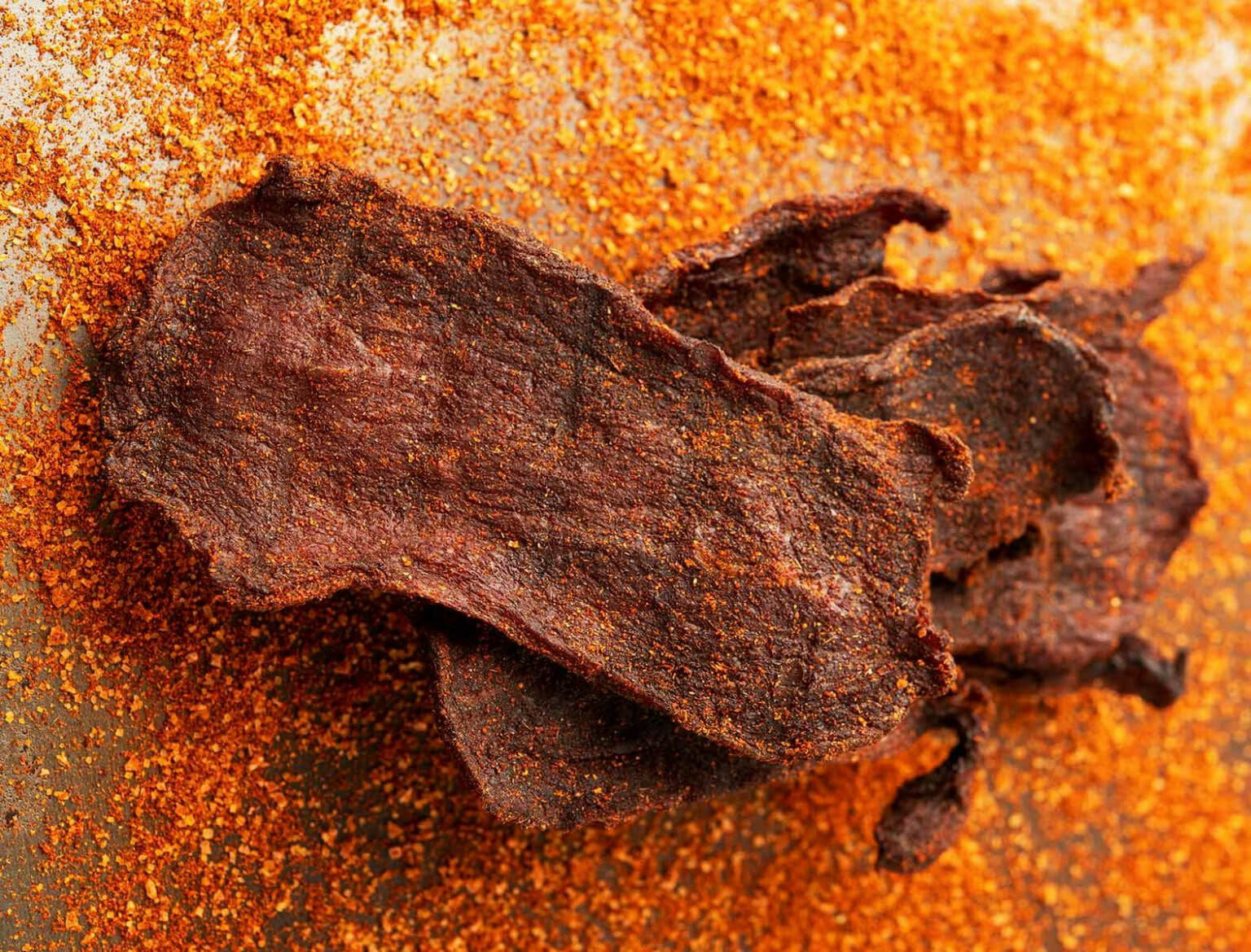 Spicy homemade beef jerky coated with dry seasoning blend